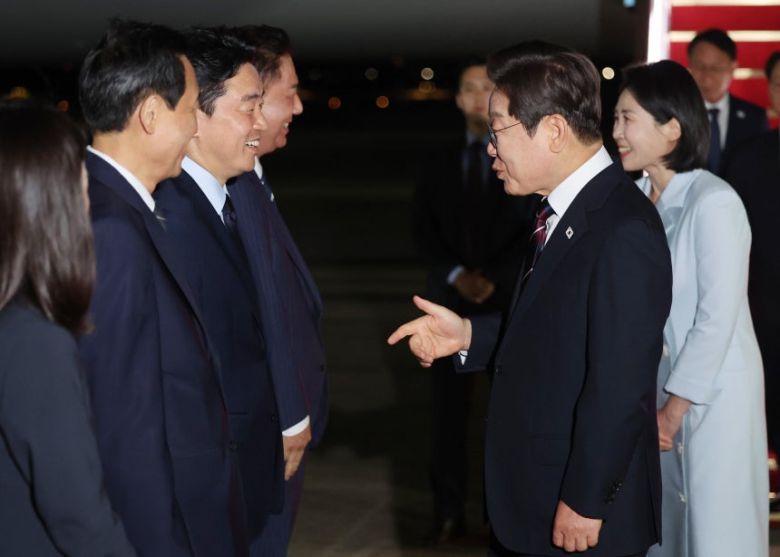 이재명 대통령이 19일 51차 주요 7개국(G7) 정상회의 일정을 마친 뒤 성남 서울공항에 도착해 마중 나온 강훈식 대통령비서실장과 대화하고 있다. [연합]