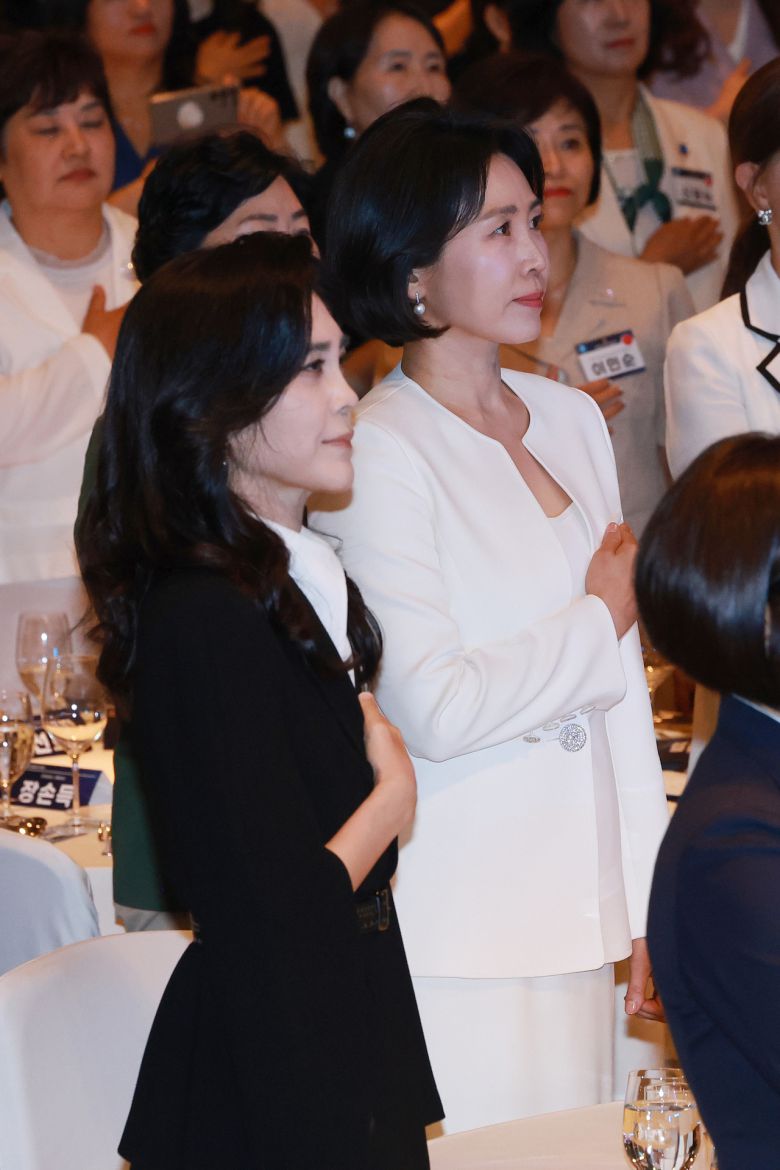 이재명 대통령의 배우자 김혜경 여사가 1일 서울 중구 신라호텔 다이너스티홀에서 열린 제4회 여성기업주간 개막식에 참석해 국기에 경례하고 있다. 왼쪽은 이부진 호텔신라 사장. [연합]