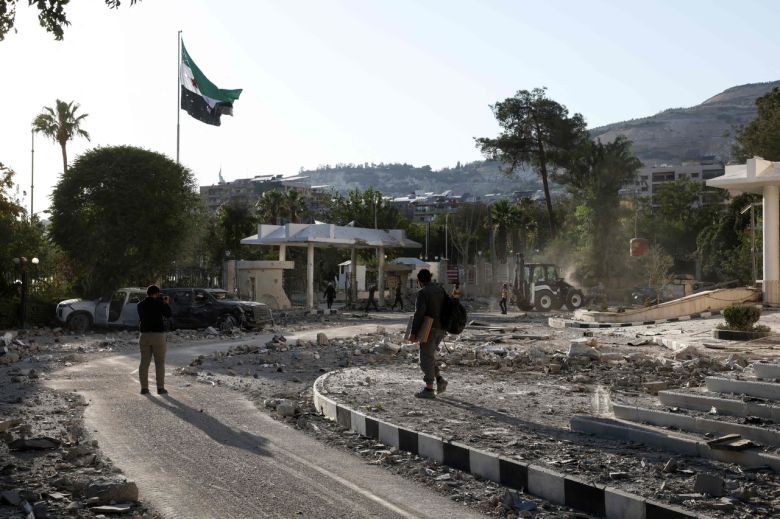 시리아 군 관계자가 16일(현지시간) 일부 부서진 국방부 청사를 촬영하고 있다. [AFP]