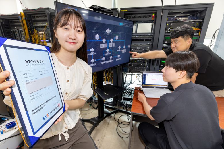 KT와 코위버 직원이 양자키분배 기술 적용 장비를 점검하고, 보안 인증서를 소개하는 모습 [KT 제공]