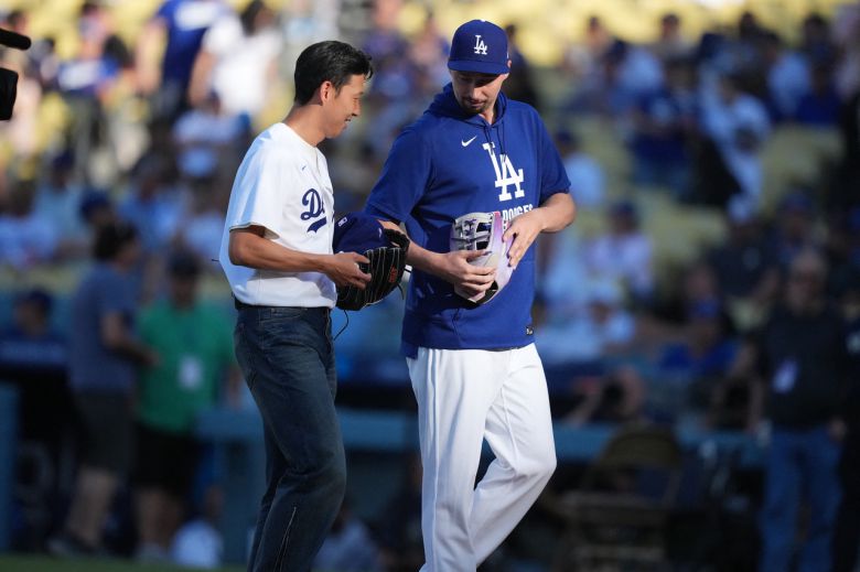 Aug 27, 2025; Los Angeles, California, USA;  Los Angeles Dodgers pitcher Blake Snell (7) walks with LAFC soccer forward Son Heung-min (7) at Dodger Stadium. Mandatory Credit: Kirby Lee-Imagn Images