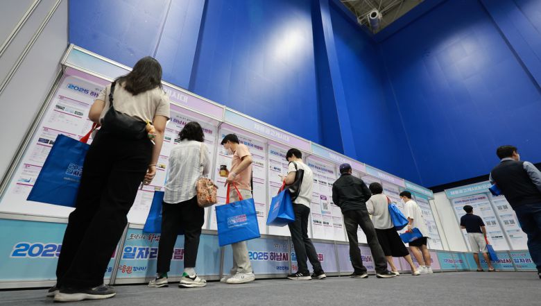 채용 박람회에서 일자리를 찾고 있는 사람들