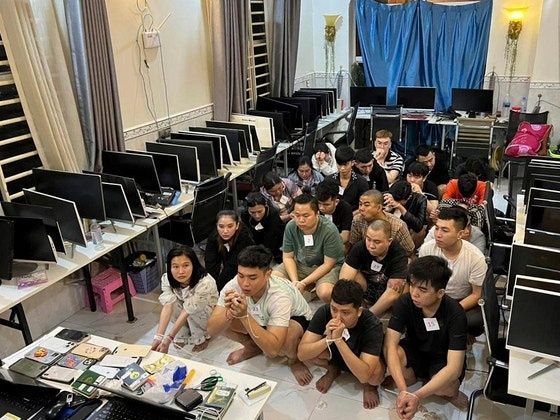 지난 7월 캄보디아 시아누크빌의 한 빌딩에서 수사 당국에 검거된 온라인 사기조직 용의자들이 포승줄에 묶여 범행 현장에 앉아 있다. 연합뉴스