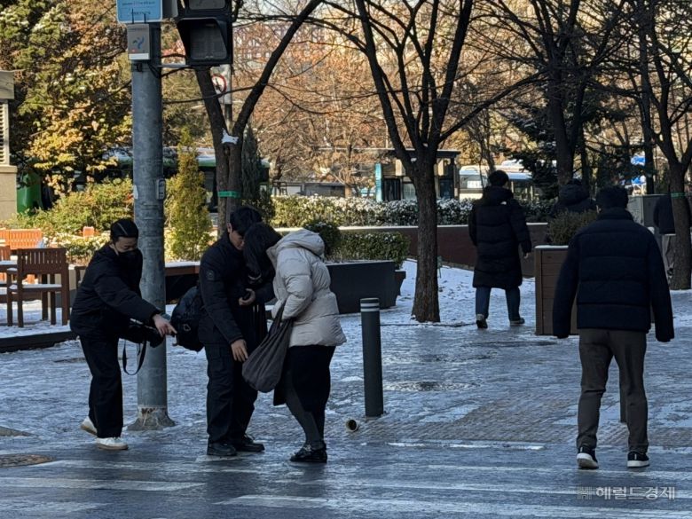 5일 오전 서울 영등포구 여의도 일대 횡단보도에서 한 행인이 급히 뛰다가 넘어져 다른 행인들의 도움을 받고 있다. 전새날 기자.