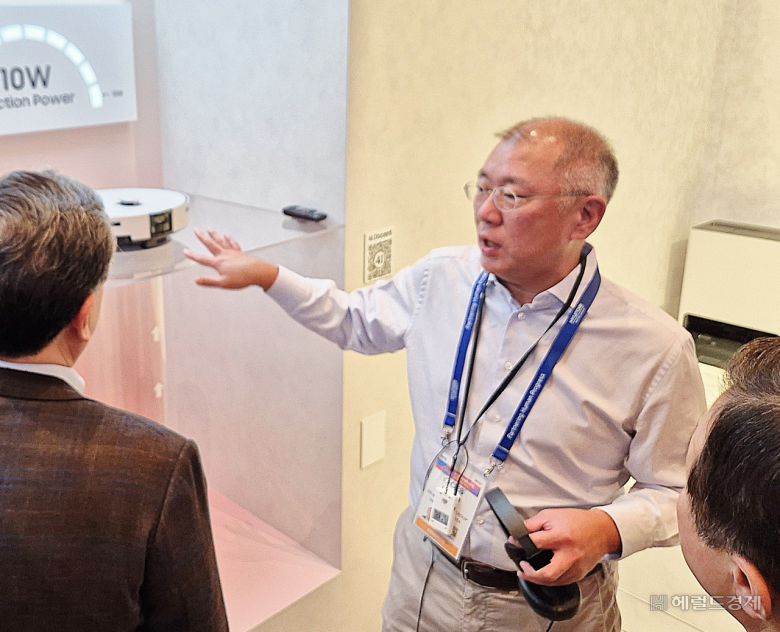 정의선 현대차그룹 회장이  6일(현지시간) 미국 라스베이거스에서 개막한 CES 2026 삼성전자 단독 전시관을 찾아 장재훈(왼쪽) 현대차 부회장, 노태문(오른쪽) 삼성전자 대표이사 사장과 ‘비스포크 AI 스팀’ 로봇청소기에 대해 얘기를 나누고 있다. 라스베이거스=김현일 기자