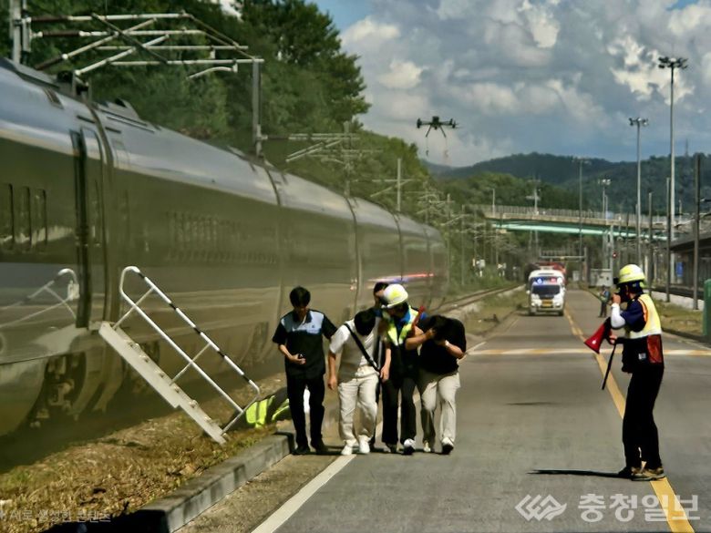 사진은 열차에서 긴급 대피하는 승객들을 코레일 초기 대응팀과 구조 요원들이 안내하는 모습
