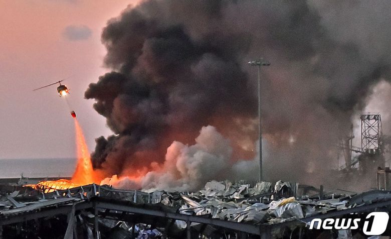 4일(현지시간) 레바논 수도 베이루트 폭발 사고 현장에 투입된 소방 헬기가 불을 끄고 있다. © AFP=뉴스1