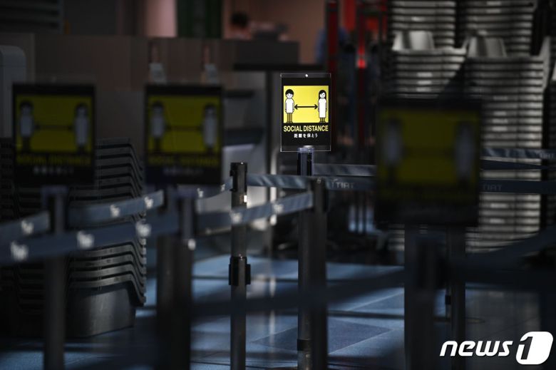폐쇄된 일본 하네다 국제공항 발권처에 '사회적 거리두기' 표지판이 세워져 있다. © AFP=뉴스1