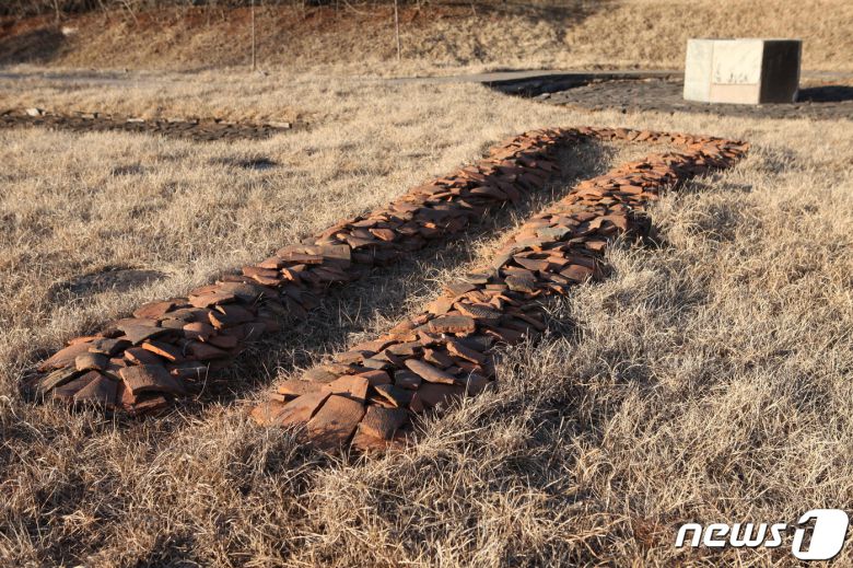 1974년 북한이 복원한 정릉사 보광전 뒤쪽에 있는 고구려시기 우물과 출토 기와 조각들. (미디어한국학 제공) 2020.11.14.© 뉴스1