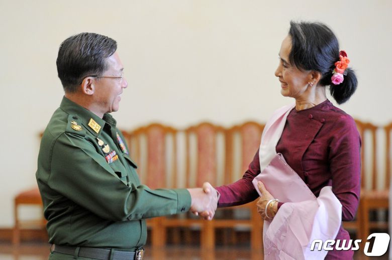 민 아웅 흘라잉 미얀마 군 최고사령관이 2015년 12월 2일 네피도의 집무실에서 집권 민주주의 민족동맹(NLD) 지도자인 아웅산 수치와 악수를 하고 있다. 미얀마 군 은 1일(현지시간) 1년간 비상사태를 선포하고 아웅산 수치 국가고문과 윈 민 대통령 등 정부 고위 인사들을 구금했으며, 민 아웅 흘라잉 최고사령관에게 권력을 이양했다. © AFP=뉴스1 © News1 우동명 기자