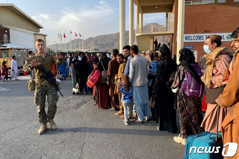 19일 (현지시간) 탈레반이 아프가니스탄을 장악한 뒤 카불의 군 공항에서 아프간인들이 미국 군용기 탑승을 위해 줄을 서 있다. © AFP=뉴스1 © News1 우동명 기자