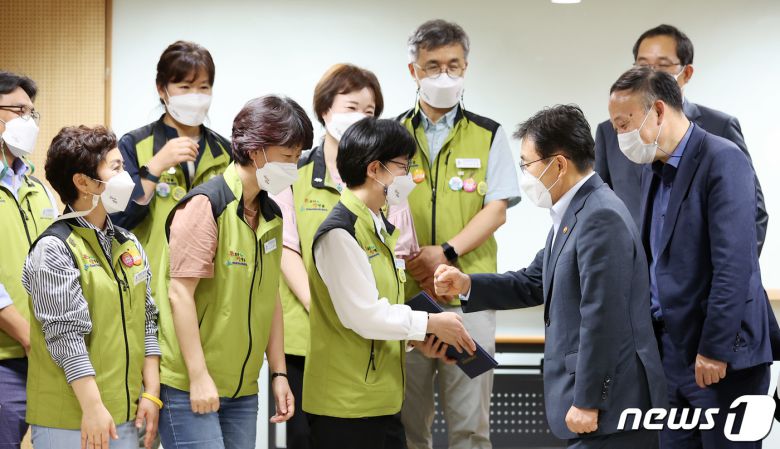 보건복지부와 전국보건의료산업노동조합(보건의료노조)의 노정실무교섭이 극적 타결된 2일 오전 서울 영등포구 의료기관평가인증원에서 권덕철 보건복지부 장관이 나순자 보건의료노조위원장을 비롯한 의료노조 관계자들과 주먹 인사를 나누고 있다. 2021.9.2/뉴스1 © News1 조태형 기자
