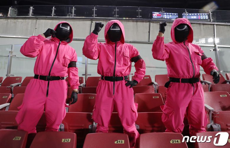25일 오후 넷플릭스 드라마 오징어게임 복장을 하고 서울 송파구 잠실야구장을 찾은 야구팬들이 LG와 롯데의 경기를 응원하고 있다. 2021.10.25/뉴스1 © News1 박세연 기자