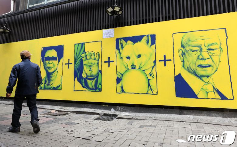 14일 오전 서울 종로구 소재 건물 외벽에 그려진 윤석열 국민의힘 대선 후보와 관련된 '손바닥 왕', '개 사과', '전두환 옹호' 논란의 키워드 벽화와 함께 옥외집회 신고 접수증이 부착돼 있다. 2021.11.14/뉴스1 © News1 조태형 기자