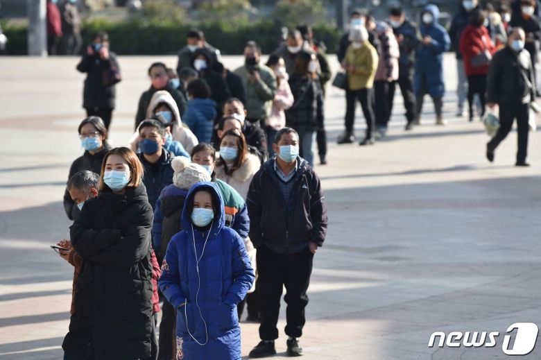 15일 (현지시간) 중국 장쑤성 난징에서 코로나19 검사 키트를 사기 위해 약국 앞에 주민들이 길게 줄을 서 있다. ⓒ AFP=뉴스1 ⓒ News1 우동명 기자