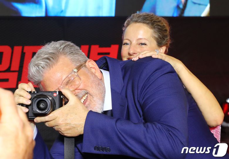 크리스토퍼 맥쿼리 감독이 29일 서울 송파구 롯데시네마 월드타워점에서 열린 영화 '미션 임파서블: 데드 레코닝 파트 원' 레드카펫 행사에서 아내 옆에서 자신이 직접 현장 분위기를 카메라에 담고 있다. ⓒ News1 권현진 기자