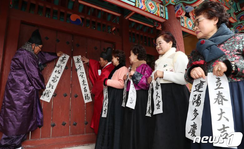 봄의 시작을 알리는 첫번째 절기 입춘(立春)을 사흘 앞둔 1일 부산 동래구 동래향교에서 지역 유림 대표들이 입춘첩을 외삼문에 붙이고 있다. 2024.2.1/뉴스1 ⓒ News1 윤일지 기자