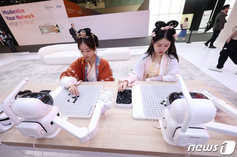 28일 오전(현지시간) 스페인 바르셀로나 피라 그란 비아에서 열린 세계 최대 이동통신 전시회 모바일 월드 콩그레스(MWC) 2024 전시장에 마련된 차이나모바일 부스에서 관계자가 로봇과 바둑을 두고 있다. 2024.2.28/뉴스1 ⓒ News1 김민지 기자