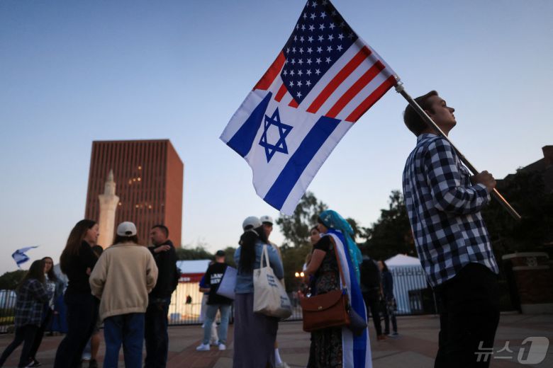 8일(현지시간) 미국 캘리포니아주 로스앤젤레스의 서던캘리포니아대학교에서 열린 이스라엘 연대 행진에서 한 남성이 성조기와 이스라엘 국기가 합쳐진 깃발을 들고 있다. 2024.05.08 ⓒ 로이터=뉴스1 ⓒ News1 정지윤 기자