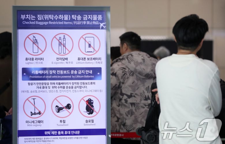 김해공항에서 발생한 에어부산 화재가 기내 선반에서 시작됐다는 목격자의 증언이 잇따르면서 휴대용 보조배터리가 화재 원인일 가능성이 제기되고 있는 가운데 30일 부산 강서구 김해국제공항 국제선 출국장에 설치된 부치는 짐(위탁수하물) 탁송 금지물품을 안내하는 전광판에 휴대폰 보조배터리 등이 표시돼 있다.  2025.1.30/뉴스1 ⓒ News1 윤일지 기자