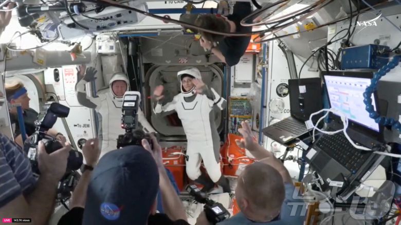 도킹을 해제하기 위해 해치를 닫기 전 스페이스 크루 드래건 캡슐 해치에서 사진을 찍고 있는 우주비행사들. ⓒ 로이터=뉴스1