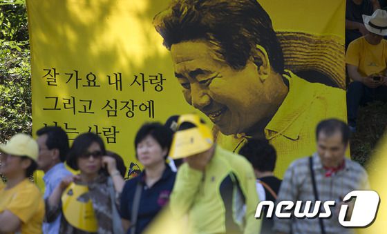 故 노무현 전 대통령 3주기 추모식이 열린 지난 2012년 5월 23일 경남 김해 봉하마을에서 추모객들이 노 전 대통령의 생전사진을 보며 추모식장으로 들어서고 있다. 2012.5.23/뉴스1