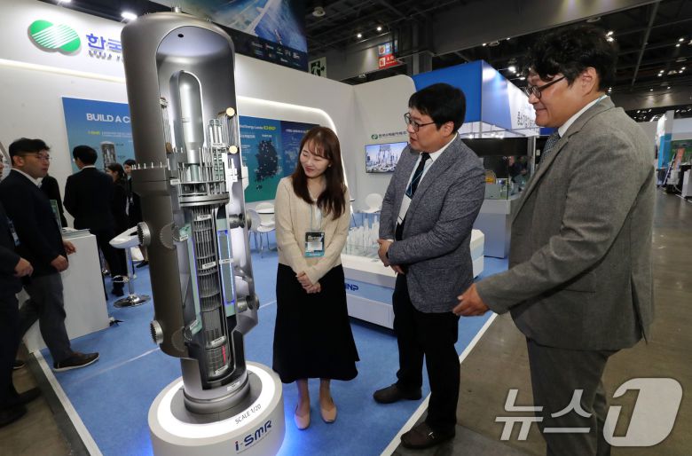 23일 경기도 고양시 킨텍스에서 열린 2024 하반기 붐업코리아 수출상담회를 찾은 관람객들이 한국수력원자력 부스에서 초소형 모듈 원전 SMR모형을 살펴보고 있다.  2024.10.23/뉴스1 ⓒ News1 박세연 기자
