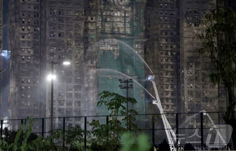 27일 홍콩 북부 타이포 구역의 아파트 단지 웡 푹 코트(Wang Fuk Court) 화재 현장에서 소방대원들이 잔불 처리를 하고 있다. 2025.11.27/뉴스1 ⓒ News1 권현진 기자