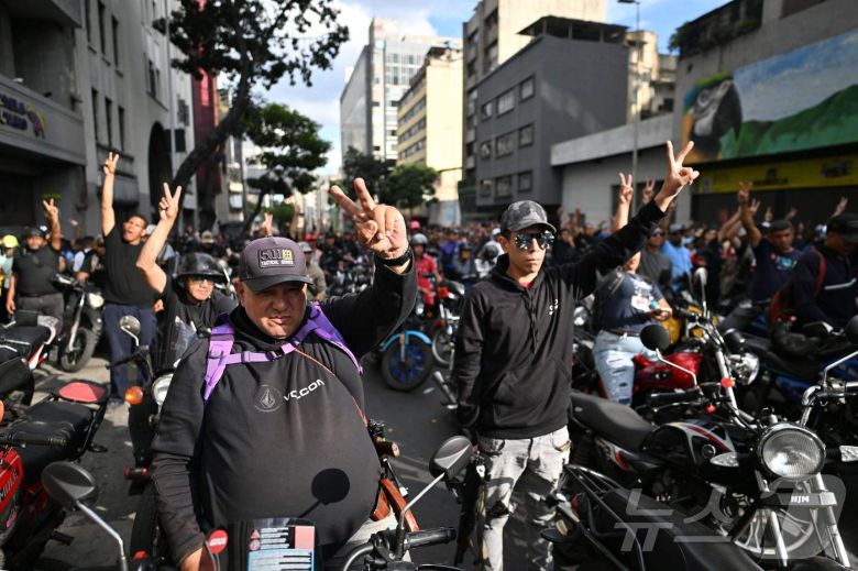 니콜라스 마두로 베네수엘라 대통령이 체포된 다음 날인 4일(현지시간) 베네수엘라 카라카스에서 마두로 지지자들이 오토바이를 타고 'V'자 손짓을 하고 있다. 2026.01.04. ⓒ AFP=뉴스1 ⓒ News1 이정환 기자