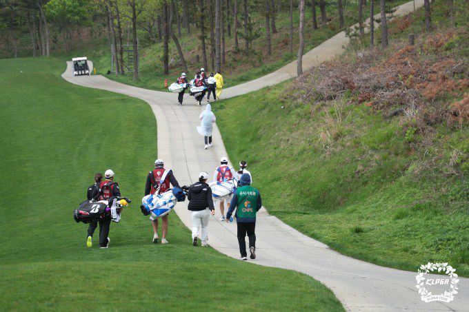 낙뢰로 경기중단 전 안전지대로 대피하는 선수들. [사진= KLPGA]