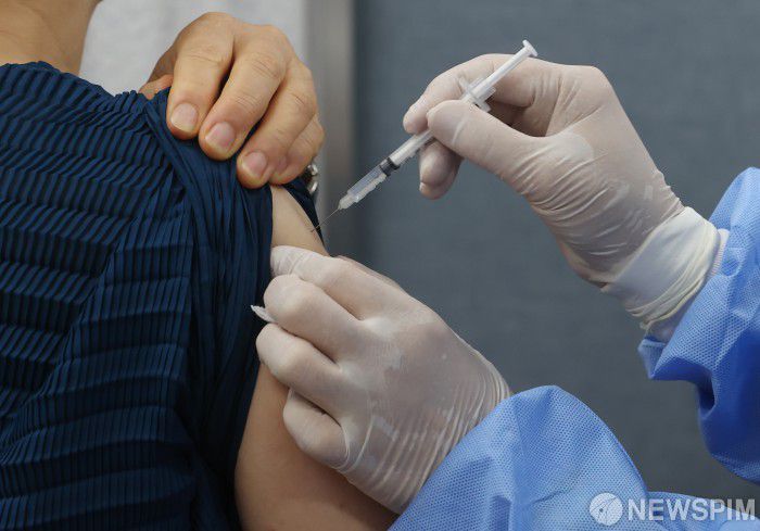 [서울=뉴스핌] 김민지 기자 = 50대와 18세 이상 성인 기저질환자에 대한 코로나19 백신 4차 접종이 시작된 18일 오전 서울 종로구보건소에서 시민이 백신 접종을 맞고 있다. 4차 접종은 카카오톡·네이버에서 잔여 백신을 예약하거나 의료기관의 예비 명단을 활용해 접종 받을 수 있다. 2022.07.18 kimkim@newspim.com