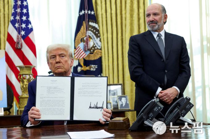 지난 13일(현지시간) 백악관 집무실에서 행정명령을 들고 있는 도널드 트럼프 미국 대통령(좌)과 그의 옆에 서있는 하워드 러트닉 미국 상무부 장관의 모습. [사진=로이터 뉴스핌]