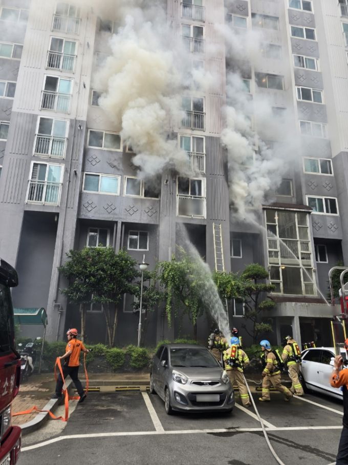 13일 낮 12시22분께 부산 북구 만덕동 15층짜리 아파트에서 2층에서 불이나 소방당국이 진화작업을 벌이고 있다. [사진=부산북부경찰서] 2025.07.13