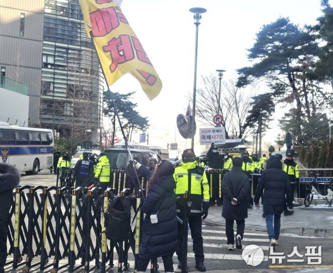 [서울=뉴스핌] 조준경 기자 = 14일 오후 서울 종로구 수송동 연합뉴스 앞에서 정의기억연대(정의연)와 위안부법폐지국민행동·국민계몽운동본부(본부) 집회가 동시에 열렸다. 정의연 집회 참가자가 '친일 매국노 처단'이라는 문구가 적힌 깃발을 흔들고 있고, 반대쪽에서는 본부 측 참여자가 '위안부 문제는 국제사기'라는 팻말을 들어 보이는 모습. 2026.01.14 calebcao@newspim.com