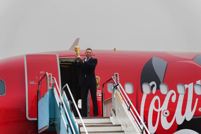 [서울=뉴스핌] 장환수 스포츠전문기자= 전 브라질 축구 국가대표 지우베르투 시우바가 16일 FIFA 월드컵 오리지널 트로피를 안고 전세기에서 내리고 있다. [사진=한국 코카-콜라] 2026.01.16 zangpabo@newspim.com