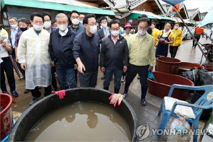 미래통합당 김종인 비상대책위원장, 주호영 원내대표가 10일 전남 구례군 오일장을 찾아 김영록 전남지사의 안내를 받으며 침수 피해 현장을 살펴보고 있다. (사진=연합뉴스)