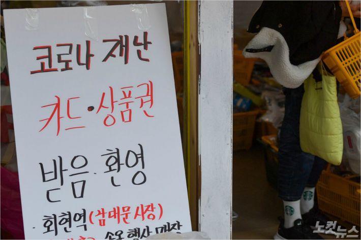 서울 중구 남대문시장의 한 상점에 재난지원금 사용 가능 안내문이 세워져 있다. 박종민기자