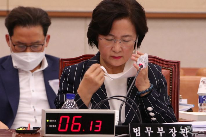 추미애 법무부 장관이 25일 오후 속개된 법사위원회 전체회의에 참석해 물을 마시기 위해 마스크를 벗고 있다. 윤창원기자