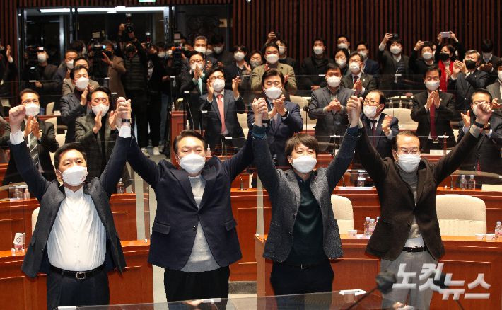 국민의힘 윤석열 대선 후보와 이준석 당 대표가 6일 오후 국회에서 열린 의원총회에서  손을 맞잡고 있다. 윤창원 기자