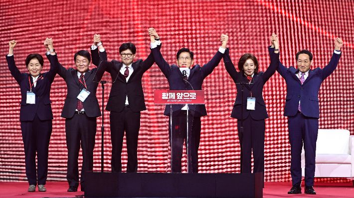 (왼쪽 네번째)가 3일 경기 고양시 킨텍스에서 열린 국민의힘 전당대회에서 후보들과 손을 들어올리고 있다. 왼쪽부터 양향자, 안철수, 한동훈, 김문수, 나경원, 유정복 후보. 연합뉴스