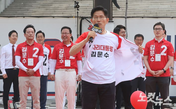 김문수 국민의힘 대선 후보가 26일 오후  경기 용인 포은아트갤러리 광장에서 열린 "내일의 기적을 만들" 집중유세에서 유권자들에게 "자신은 방탄조끼를 안 입었다"라며 겉옷을 열어젖히고 있다. 용인=황진환 기자