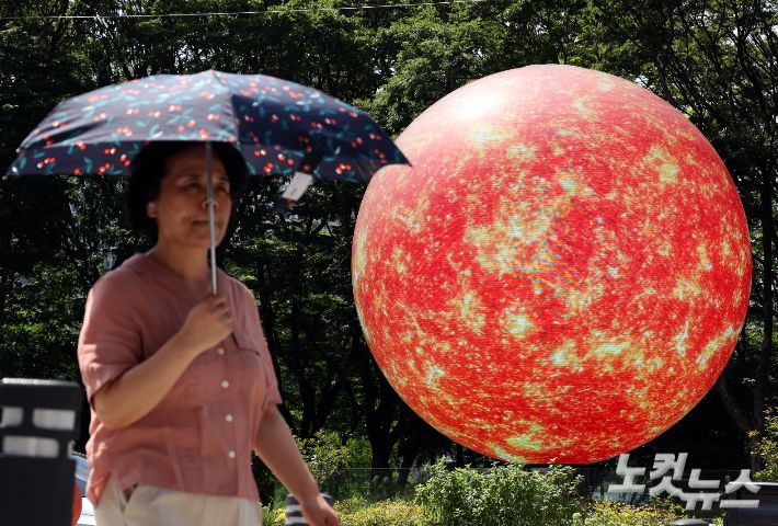 전국 대부분 지역에 폭염경보가 발효된 9일 오후 서울 송파구 조형물에 이글이글 타오르는 태양의 모습이 나오고 있다. 황진환 기자