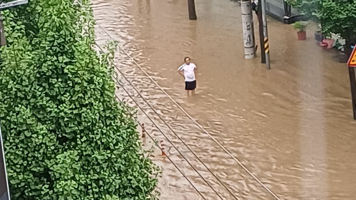 17일 오후 광주 북구 중흥동의 한 도로가 물에 잠겨 도로 유도선이 보이지 않자 인근 시민이 차량통제를 하고 있다. 독자 제공