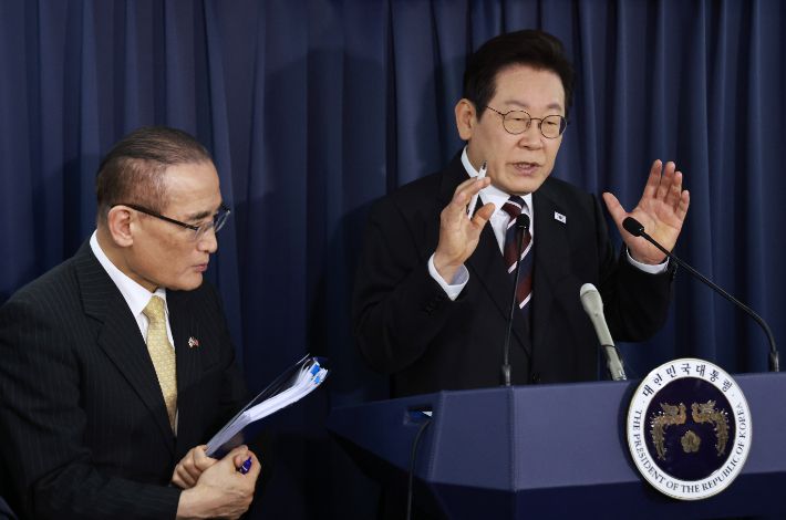 이재명 대통령이 24일(현지시간) 일본 도쿄 하네다공항 이륙 뒤 한미 정상회담을 위해 미국 워싱턴DC로 향하는 공군 1호기 기내에서 기자간담회를 하며 취재진의 질문에 답하고 있다. 이 대통령 왼쪽은 위성락 국가안보실장. 연합뉴스