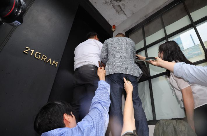 대통령 관저 이전 공사 과정에 관여하며 특혜 의혹을 받는 인테리어 업체 '21그램'에서 직원이 문을 열어주지 않아 대기하고 있다. 연합뉴스