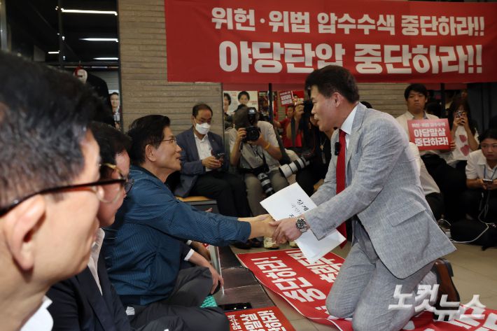 전한길 전 한국사 강사가 14일 오전 서울 여의도 국민의힘 중앙당사에서 열린 중앙윤리위원회 회의에 출석하며 전날 특검의 국민의힘 당사 압수수색을 규탄하며 농성중인 김문수 당대표 후보와 인사를 하고 있다. 윤창원 기자
