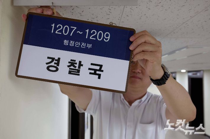 서울 종로구 정부서울청사 내 경찰국 사무실 앞에서 관계자가 현판을 제거하고 있다. 박종민 기자