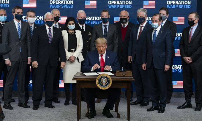 도널드 트럼프 미국 대통령이 8일(현지시간) 백악관에서 열린 '백신 최고회의'에 참석해 미국인들에게 신종코로나바이러스 감염증(코로나19)백신을 우선 접종하도록 하는 내용의 행정명령에 서명을 하고 있다. 워싱턴=AP연합뉴스