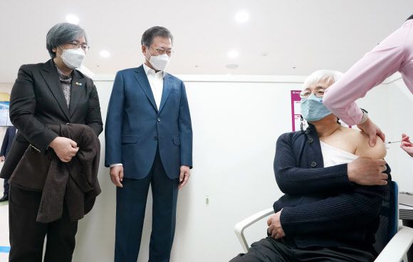 문재인 대통령과 정은경 질병관리청장이 26일 코로나19 백신 접종 참관을 위해 서울 마포구보건소를 방문해 백신 접종을 받는 김윤태 푸르메 넥슨어린이 재활병원 의사를 지켜보고 있다. 뉴시스