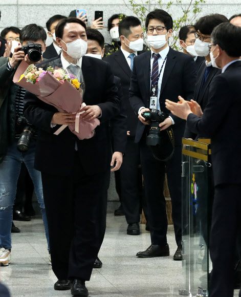 윤석열 검찰총장이 4일 오후 서울 서초구 대검찰청 현관에서 열린 퇴임식을 마친 후 꽃다발을 들고 청사를 나서고 있다. 뉴스1